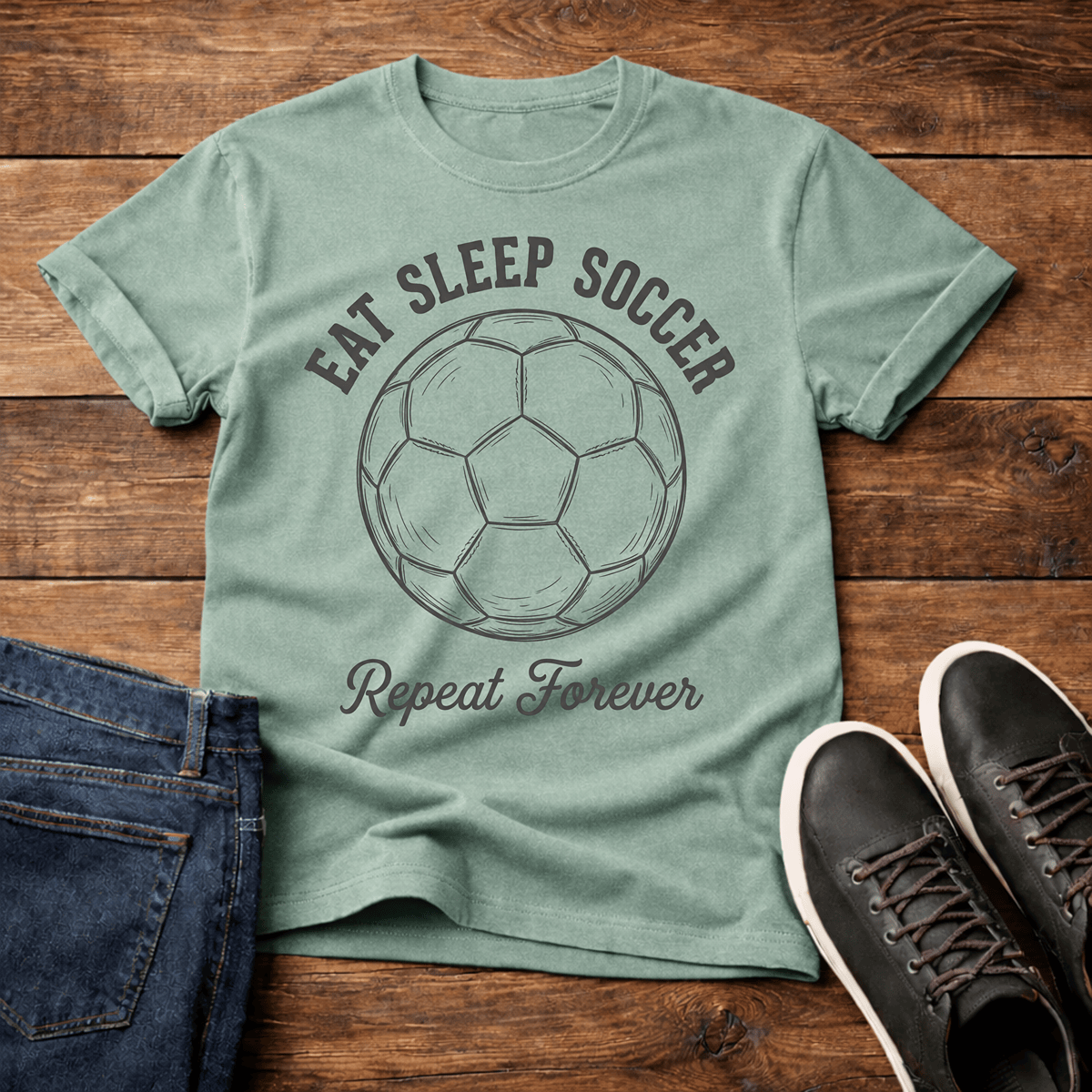 Eat Sleep Soccer Repeat T-Shirt in green with a soccer ball graphic and text design.