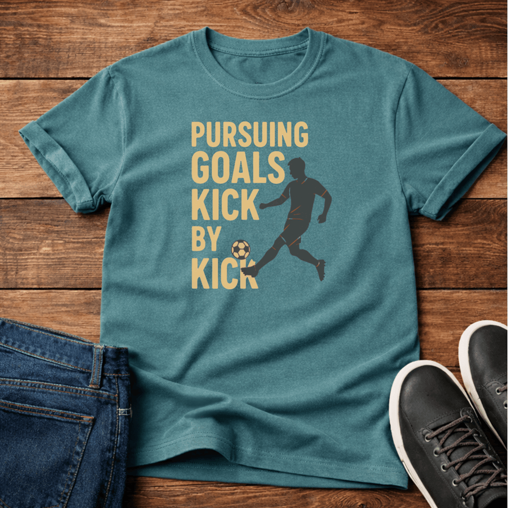 Pursuing Goals T-Shirt in teal with a soccer graphic and motivational text.