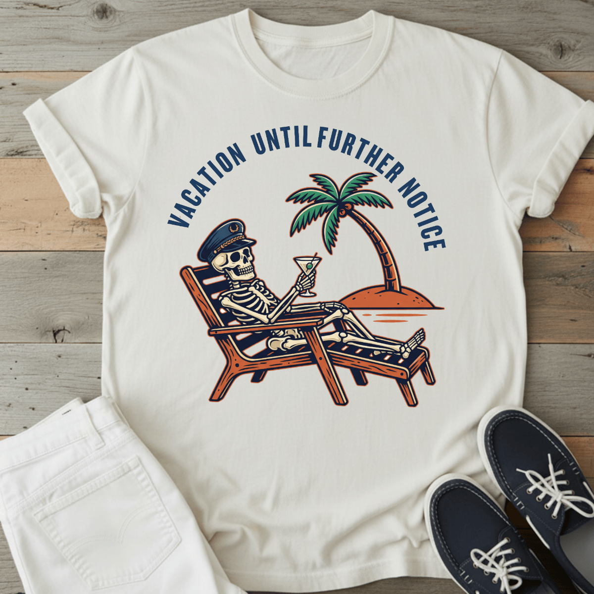 Optimistic Castaway T-Shirt featuring a skeleton in a captain's hat relaxing with a drink under a palm tree.