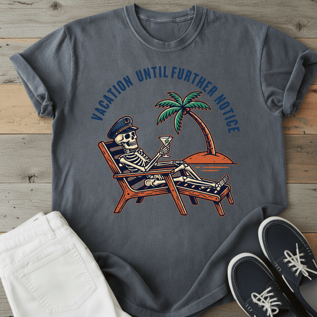 Optimistic Castaway T-Shirt featuring a skeleton relaxing with a drink under a palm tree, in dark gray.